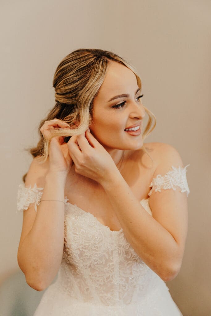 bride putting on earring