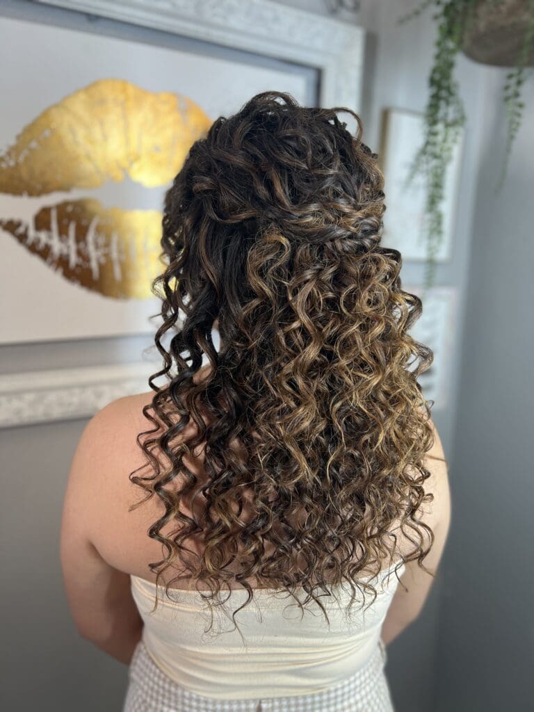 Half-up curly hairstyle with defined ringlets and warm brunette tones, styled by Pacheco Beauty for long-lasting bounce