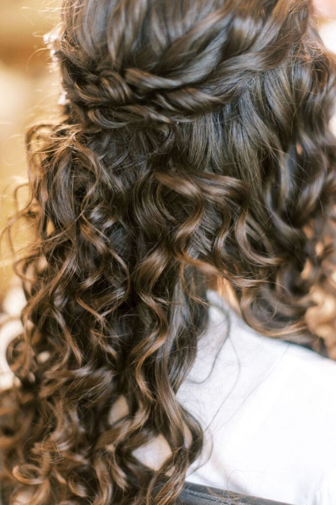 Close-up of twisted half-up curly hairstyle showing hydrated, frizz-free curls with beautiful shine